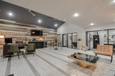 a living room with a table and chairs and a television